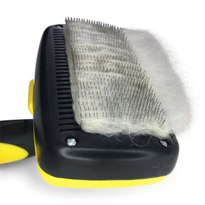 Self-cleaning button on the Deshedding Slicker Brush